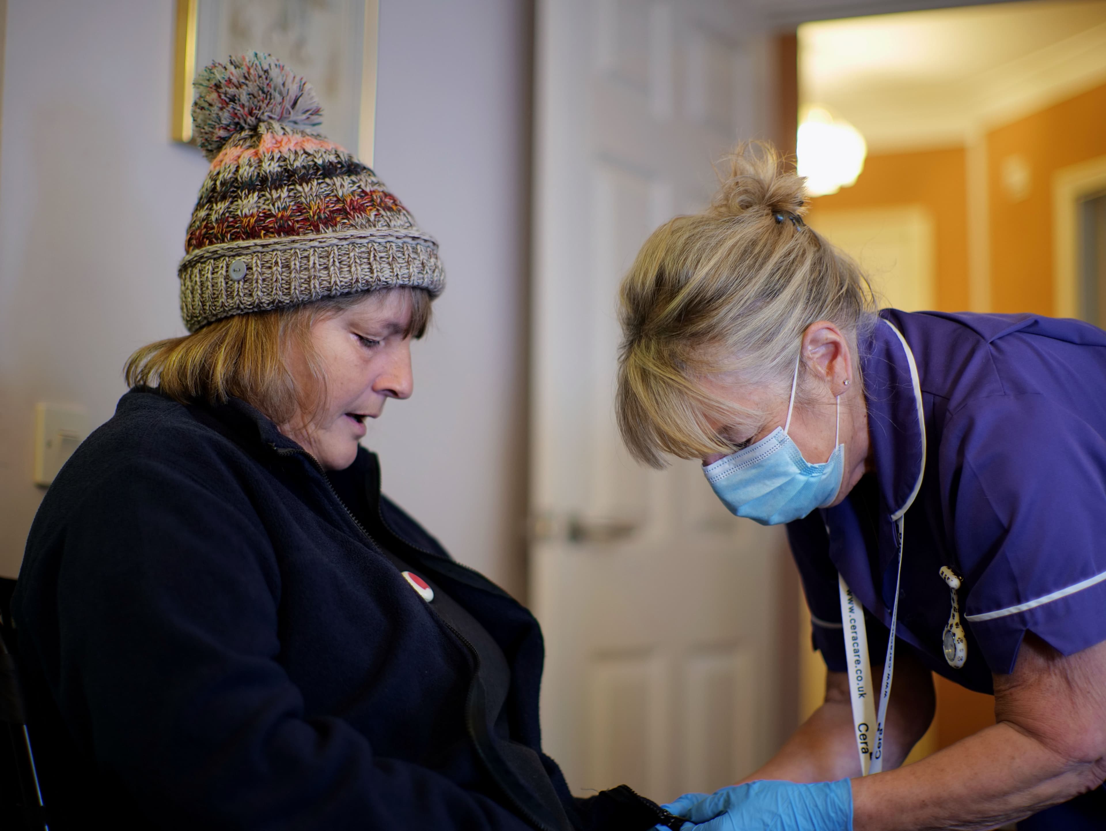 Winter carer and service user in hat